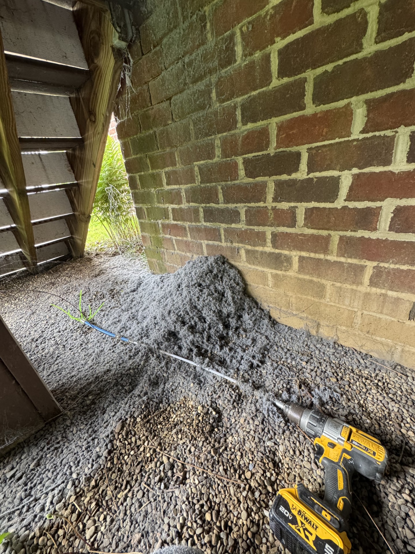 Large lint pile removed against brick wall